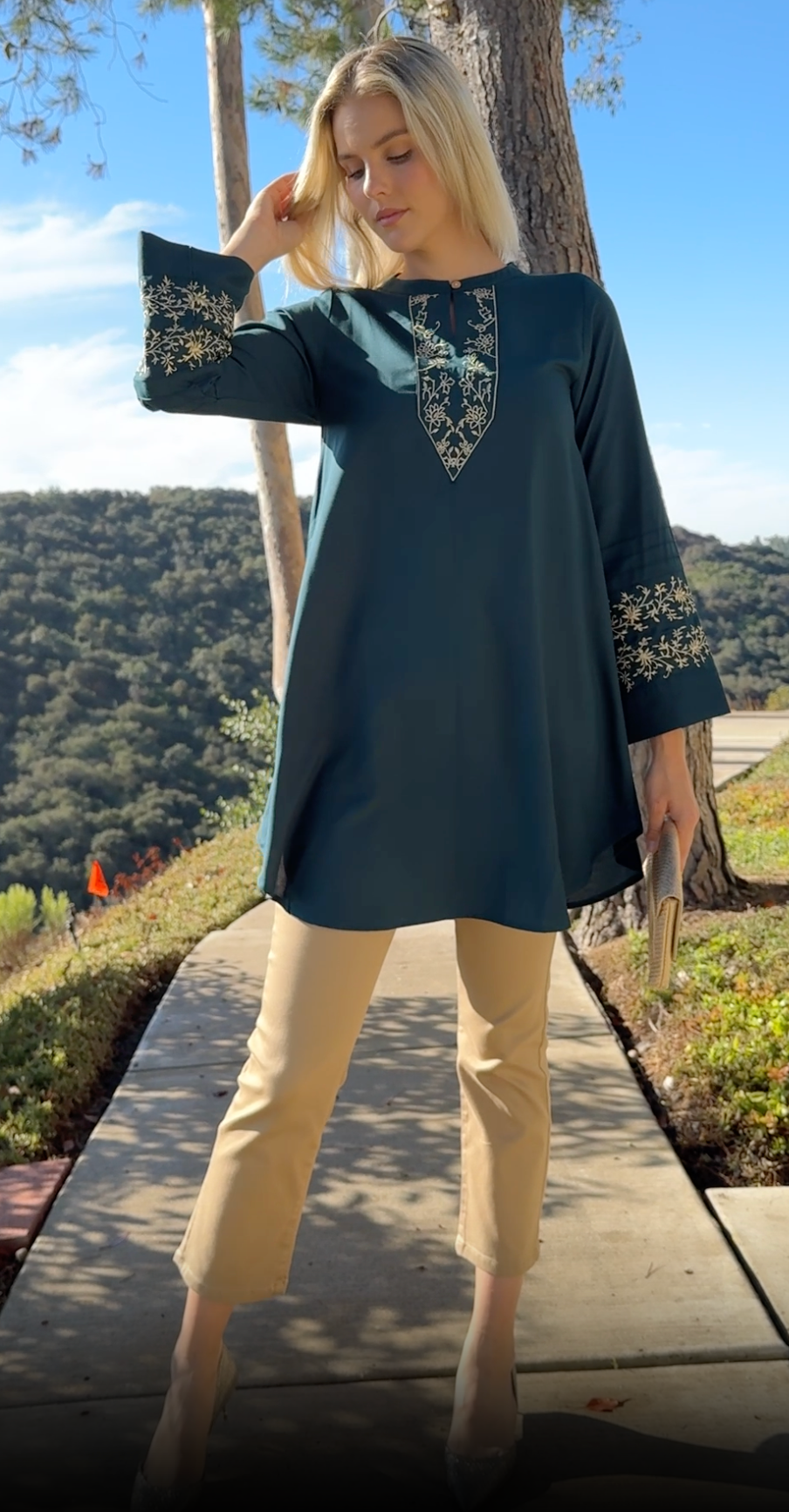 Woman outside wearing Zoha tunic in Teal/Gold.