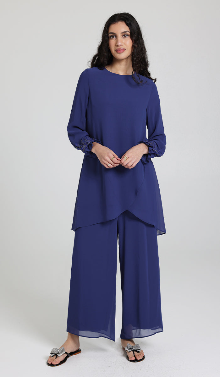 Woman wearing Seema tunic in Blue with Blue pants and sandals.
