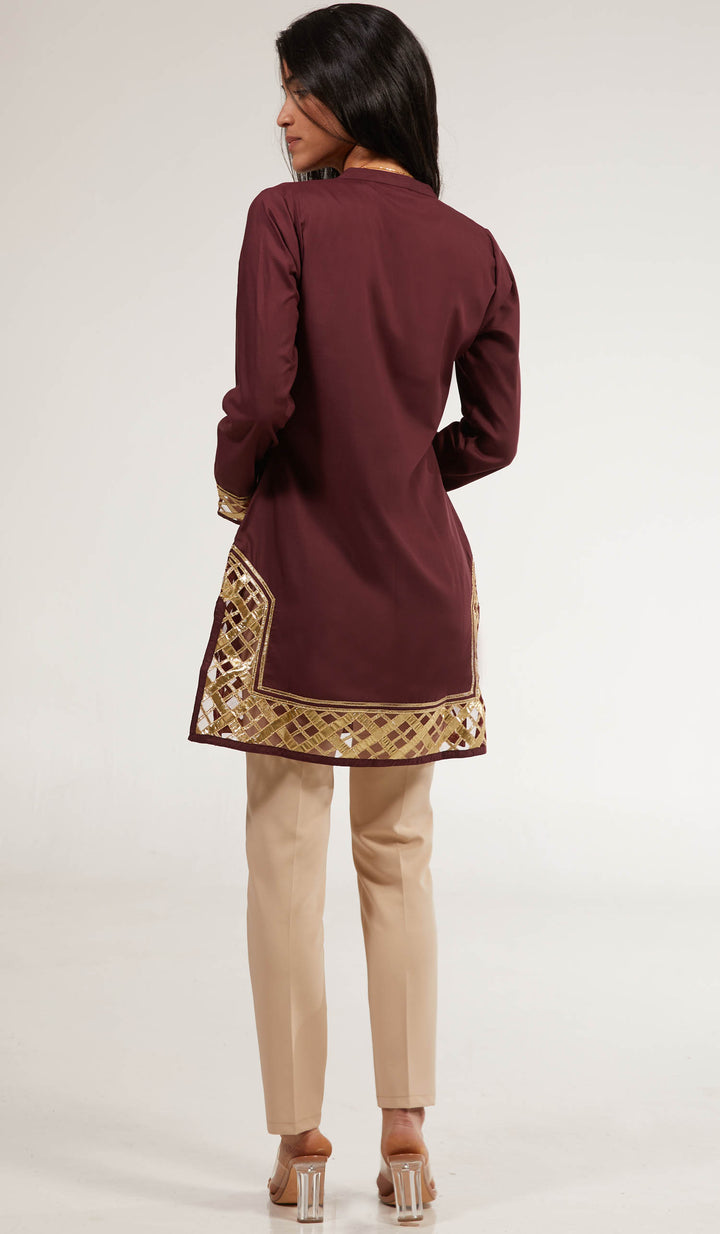 Back view of woman wearing Behnaz tunic in Orchid with khaki pants and heels.
