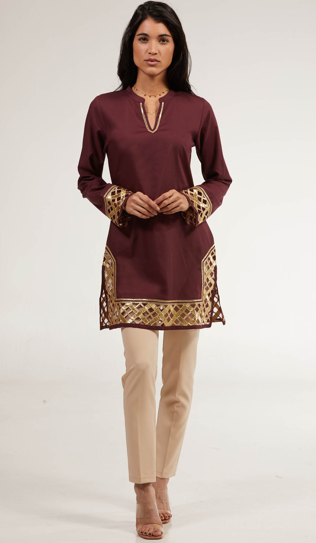 Woman wearing Behnaz Gold Embellished tunic in Orchid with khaki pants and heels.