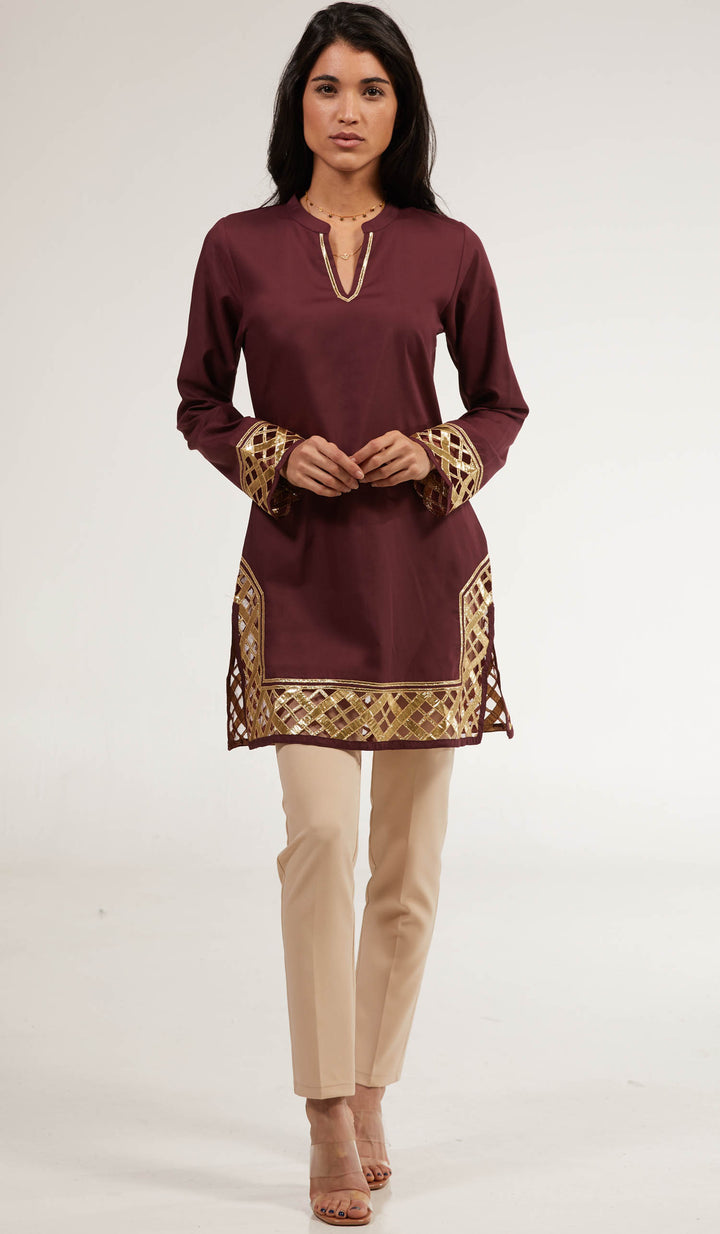 Woman wearing Behnaz Gold Embellished tunic in Orchid with khaki pants and heels.