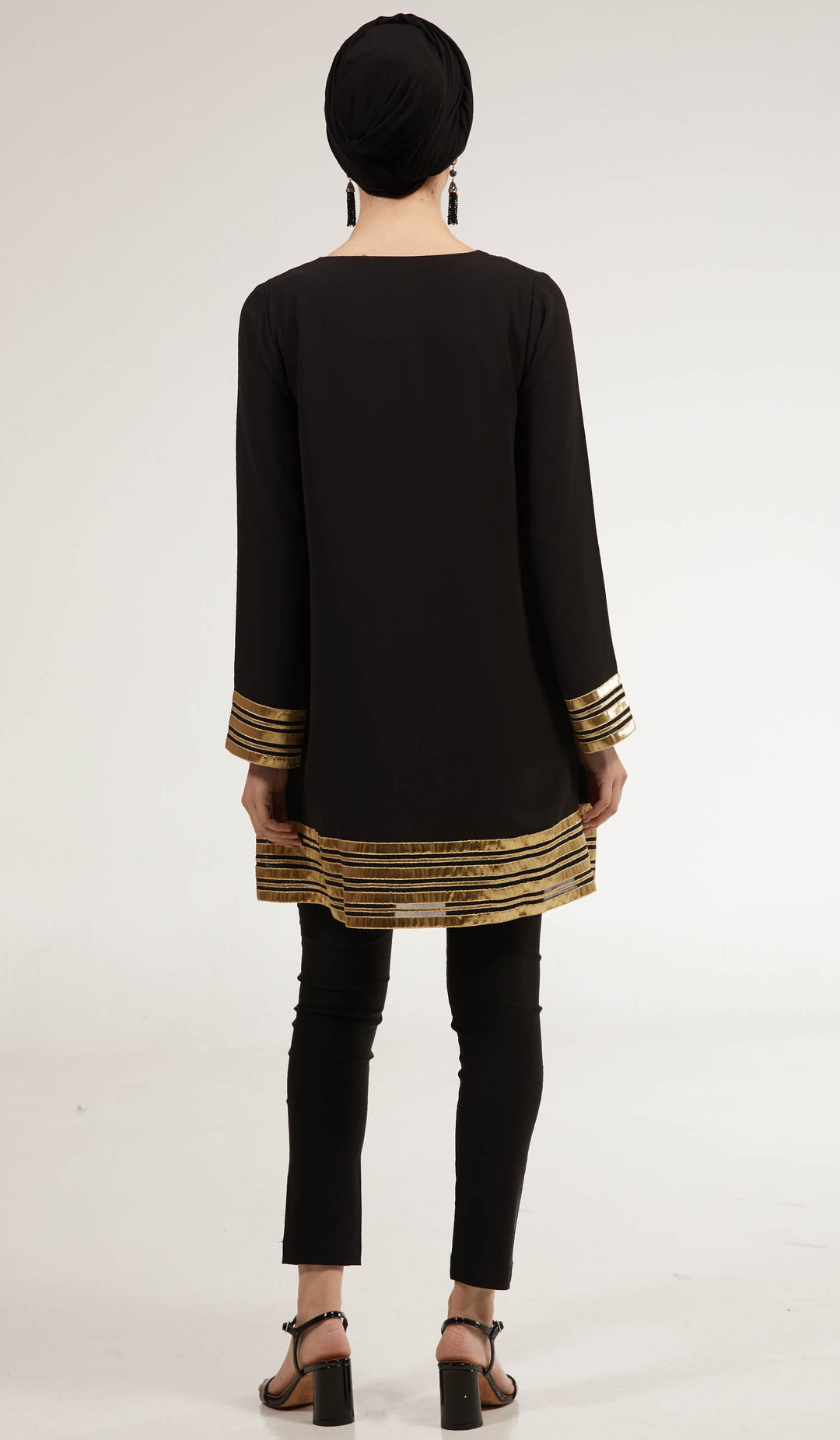 Back view of Sultana tunic in Black with black pants and heels.
