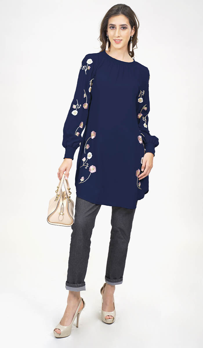 Model wearing jeans with modest Iman tunic in Navy with heels.