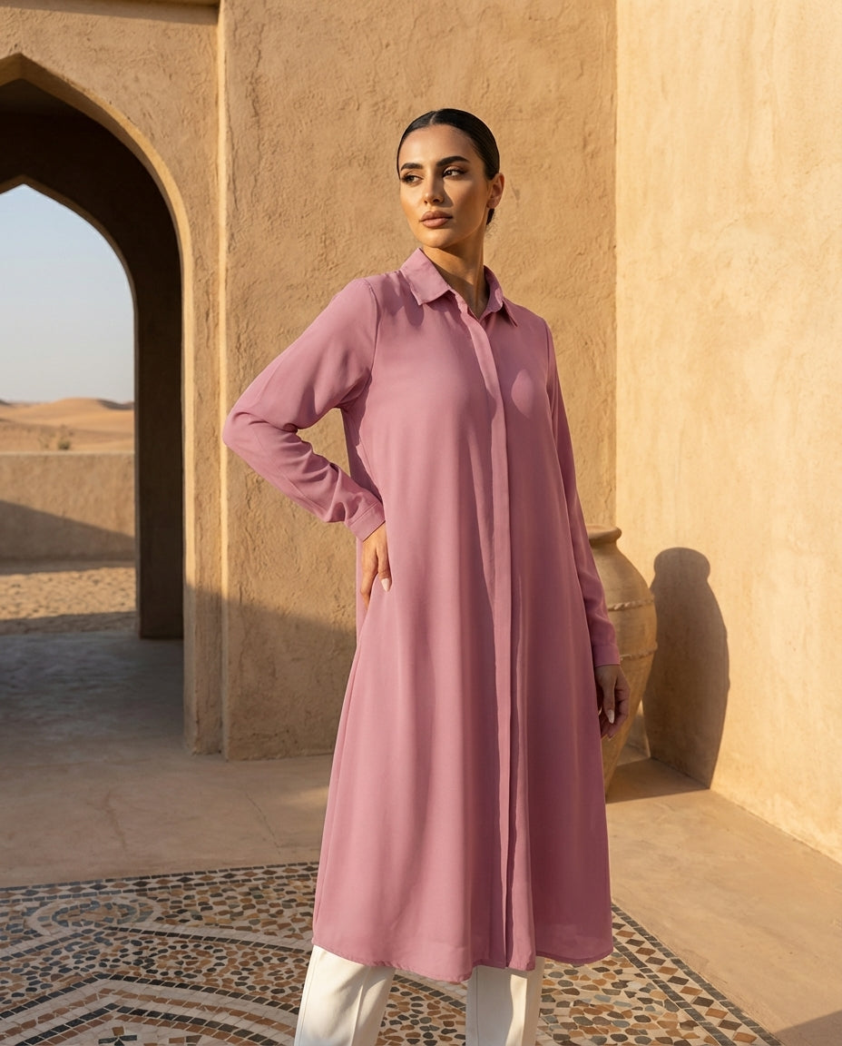 Woman wearing long pink chiffon buttondown shirt
