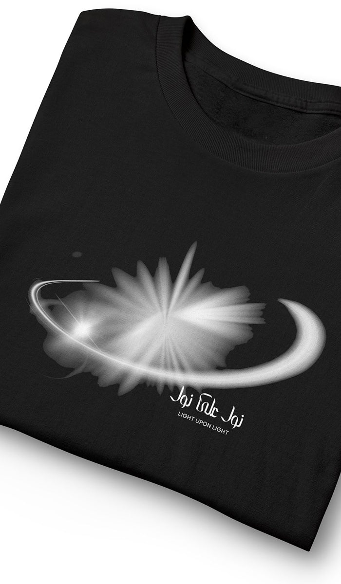 A folded black t-shirt featuring a white and gray graphic of a flower-like burst with a crescent orbit and the text 'Jai Hike Jai' with 'HATE UPHOLD LAW' underneath.