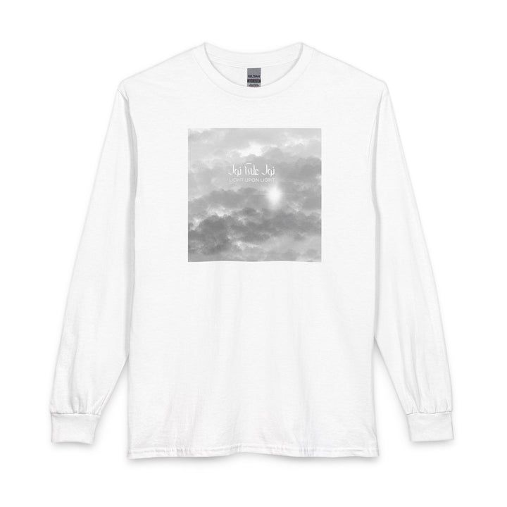 A white long-sleeve crewneck t-shirt featuring a square grayscale graphic print on the chest depicting clouds and Arabic Calligraphy