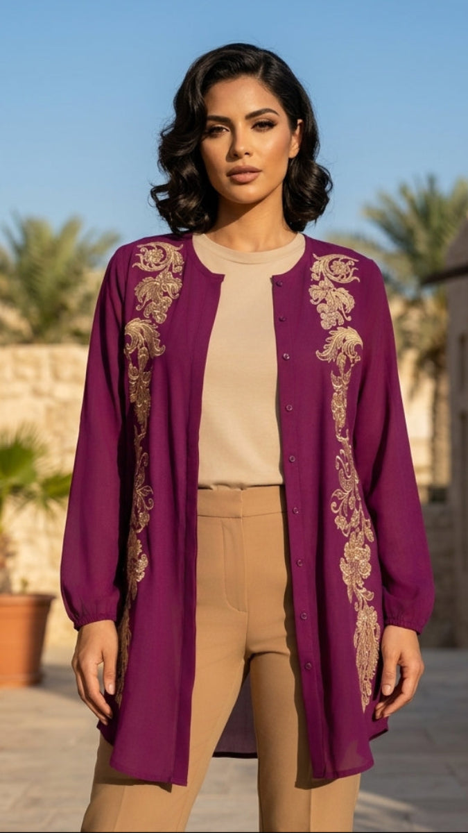 Woman wearing a purple embroidered cardigan with a beige top and pants outdoors.