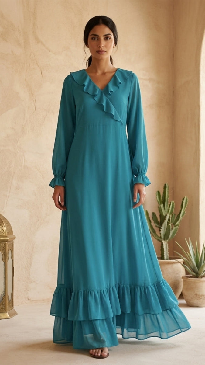 Woman in a teal dress standing in a sunlit room with architectural elements and plants.