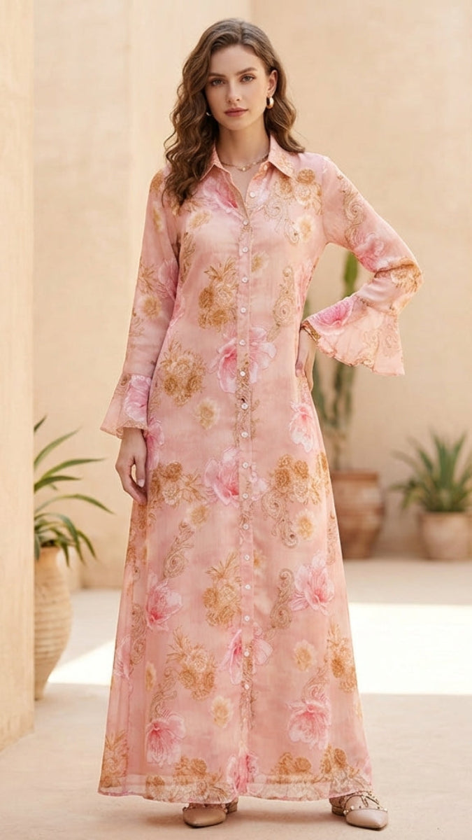Woman in a floral dress standing in a sunlit outdoor setting with architectural elements.