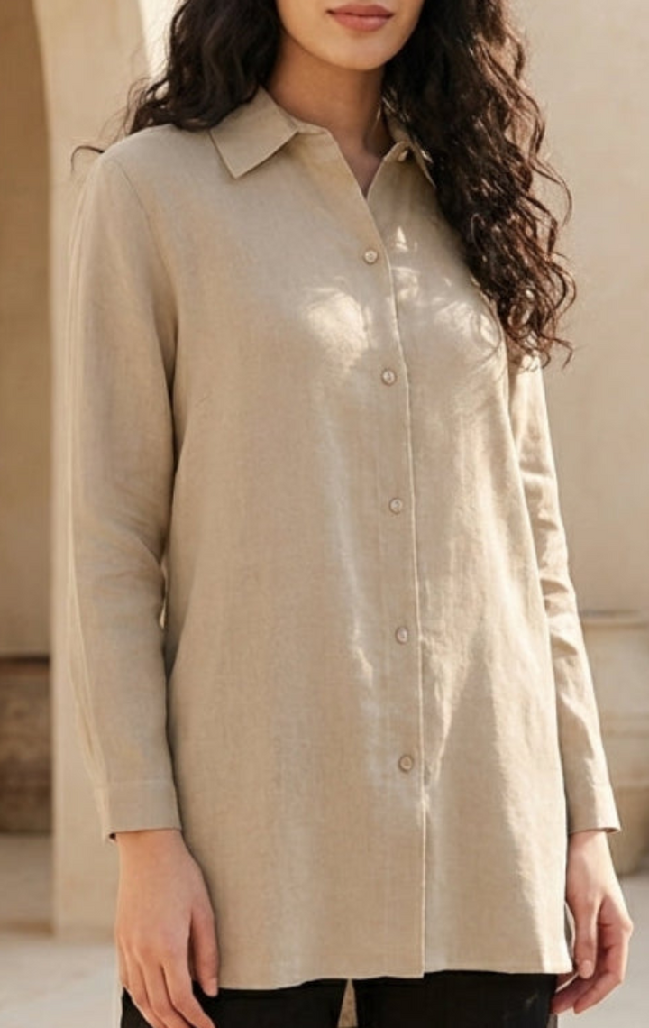 Woman wearing a beige linen button-up shirt against a neutral background