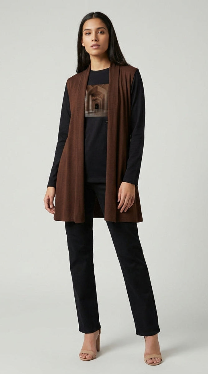 Woman wearing a brown cardigan over a black outfit on a white background