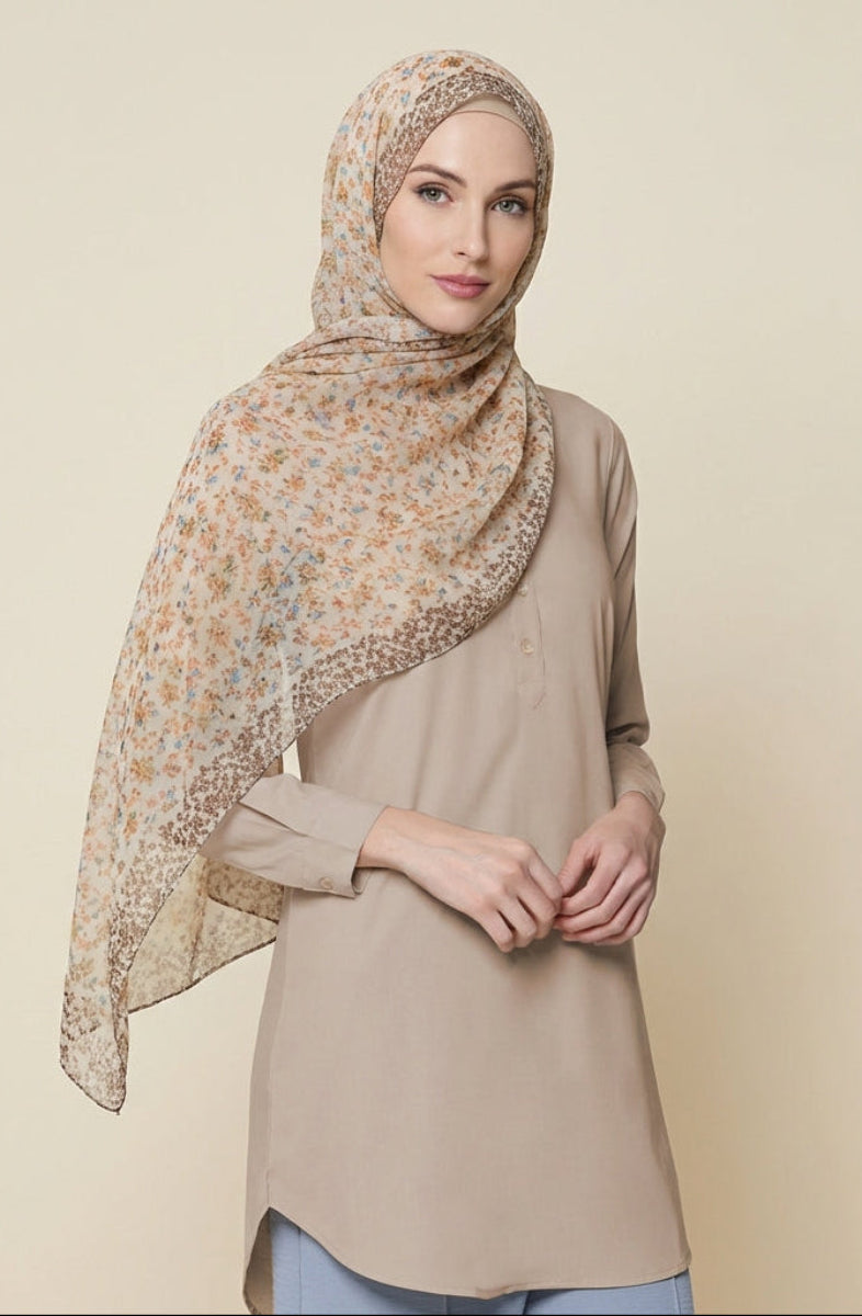 Woman wearing a beige hijab with floral patterns on a beige background