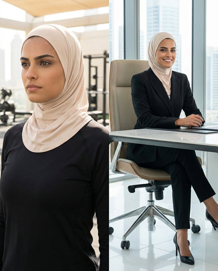 Woman in hijab standing and sitting at a desk in an office setting.