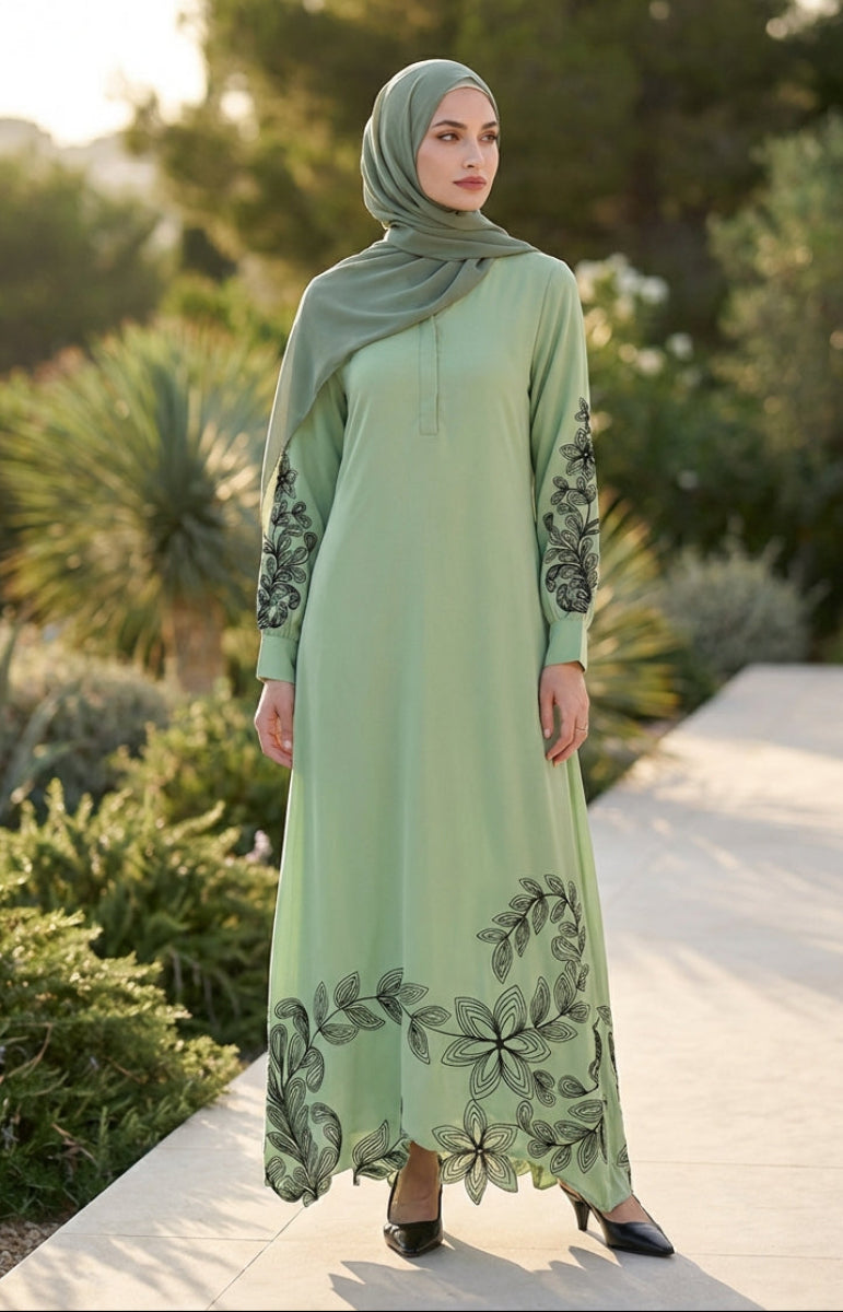 Woman wearing a light green dress with floral patterns in an outdoor setting