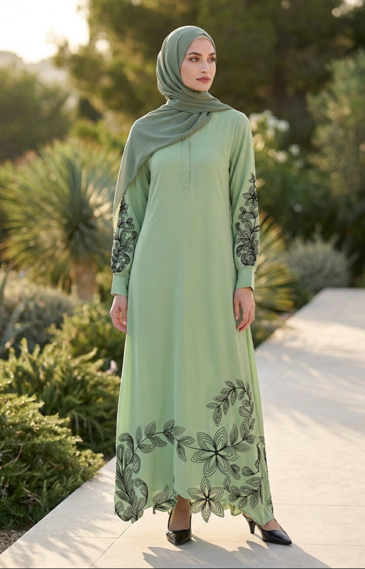 Woman wearing a light green dress with floral patterns in an outdoor setting