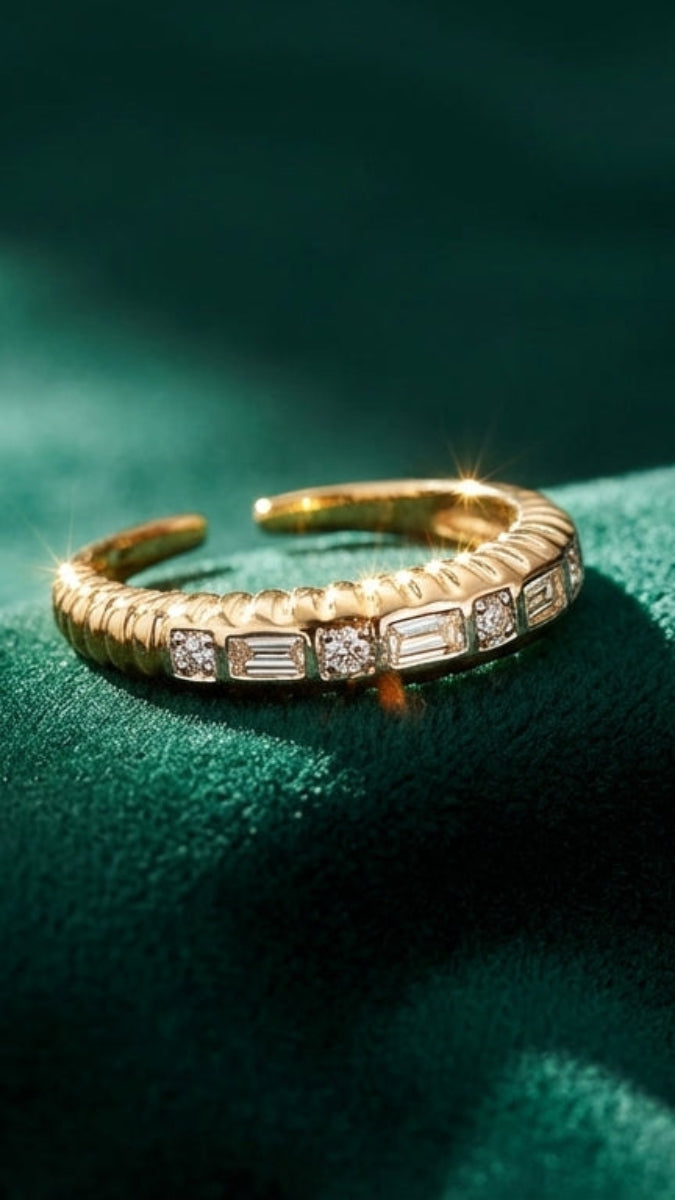 Gold ring with gemstones on a green fabric background