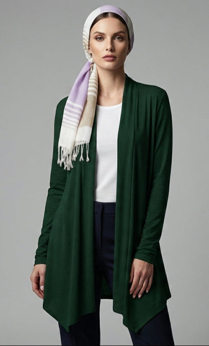 Woman wearing a green cardigan and white headscarf on a gray background