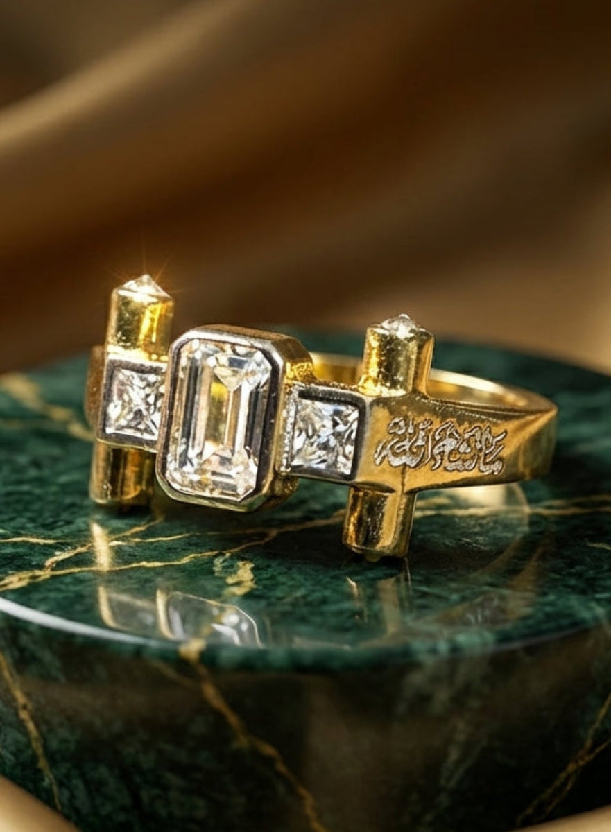 Gold ring with diamond accents on a green marble base with gold fabric background