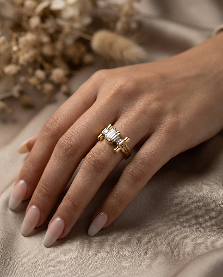 Gold ring on a hand with a neutral background