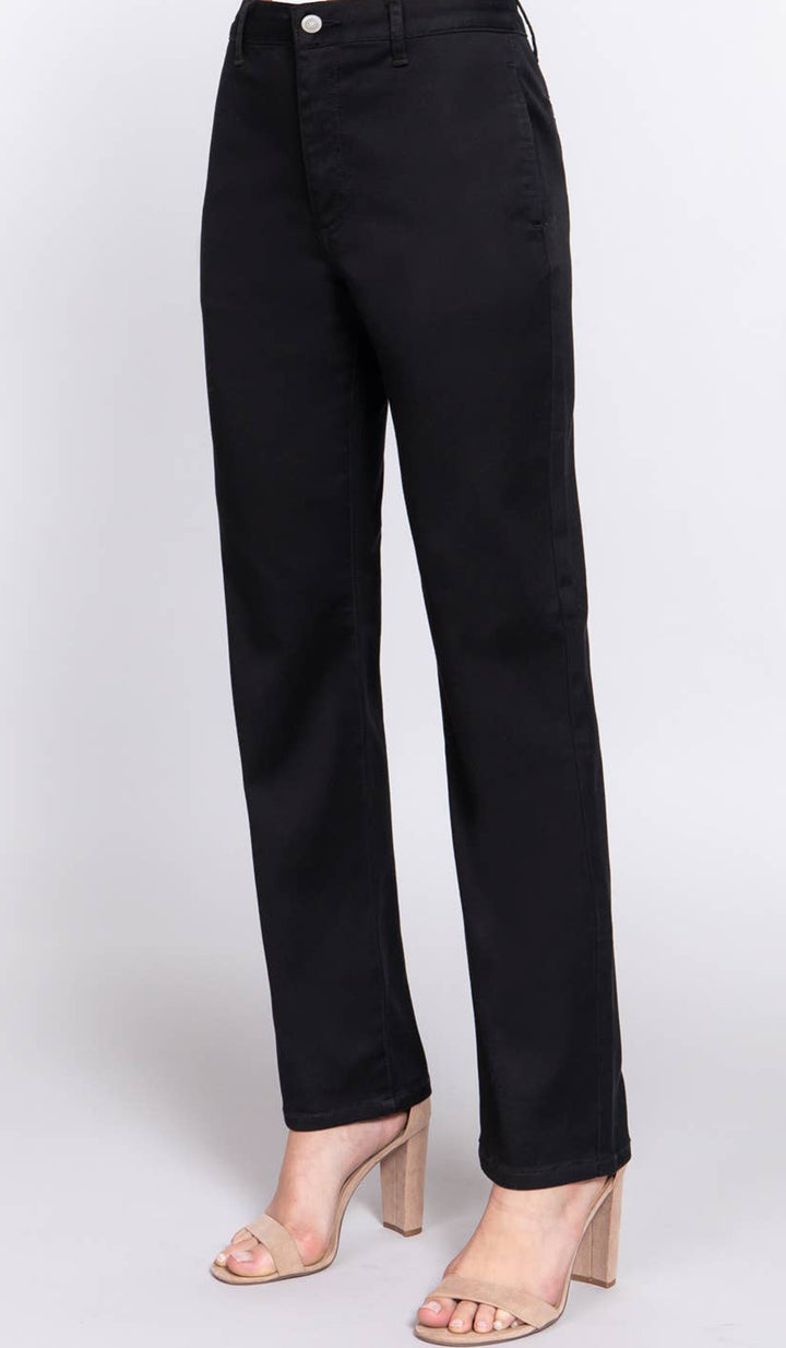 Woman wearing Erem pants in Black with heels. 