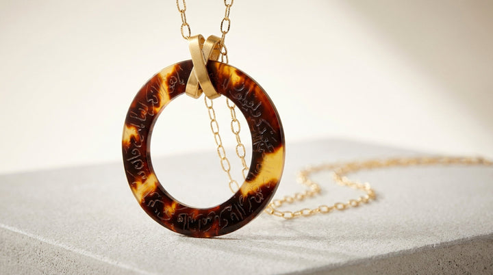arabic calligraphy engraved Tortoiseshell pendant necklace on a light background