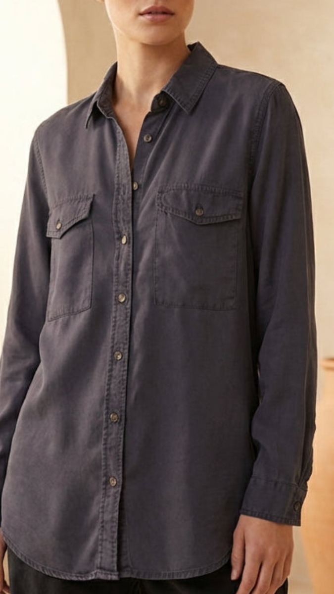 Dark gray button-up shirt worn by a person against a neutral background