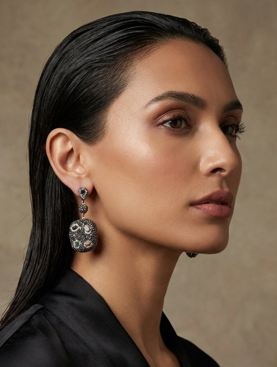 Woman wearing elegant earrings against a neutral background