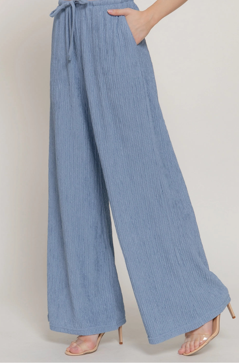 Light blue wide-leg pants worn by a person on a plain background