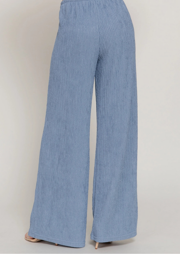 Light blue wide-leg pants on a plain background