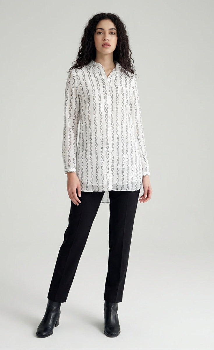 Woman wearing a white patterned shirt and black pants on a white background