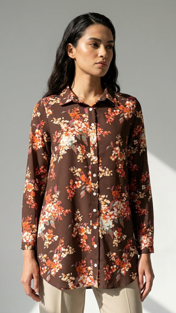 Woman wearing a floral blouse against a gray background
