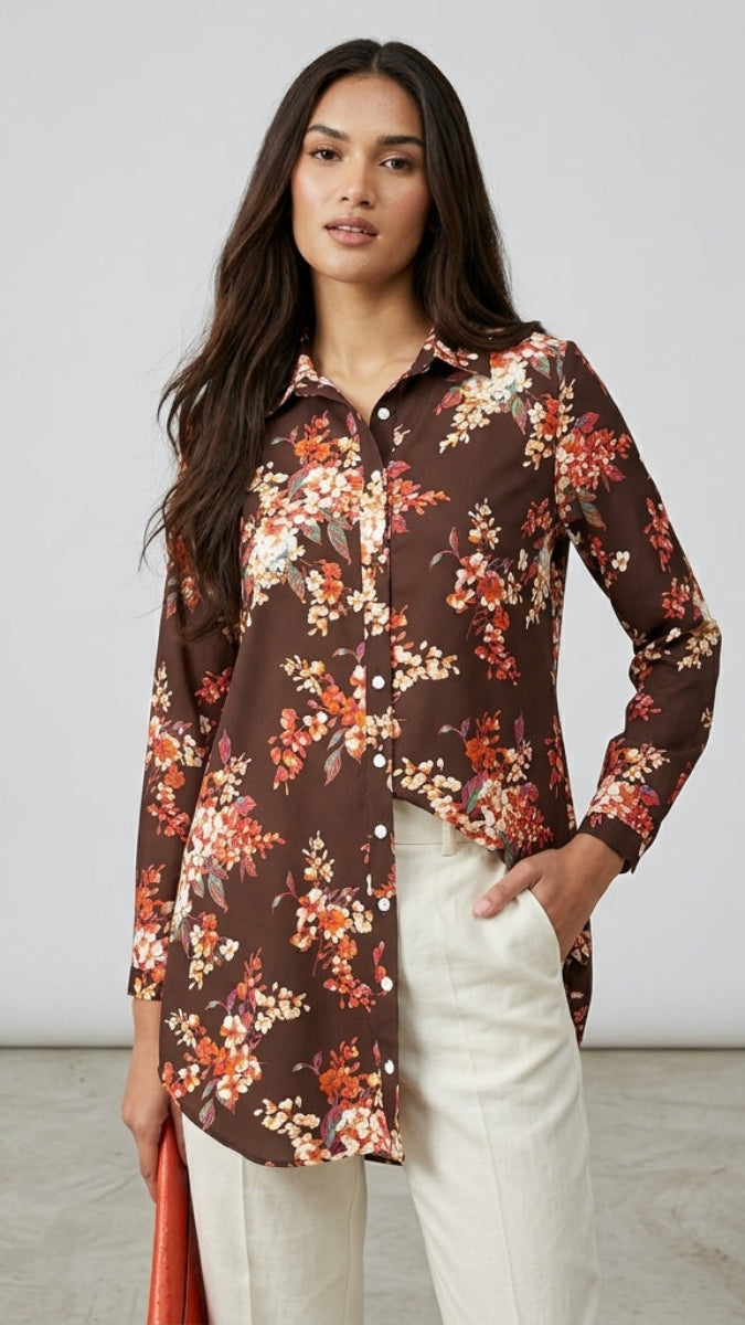 Woman wearing a floral shirt with a plain background