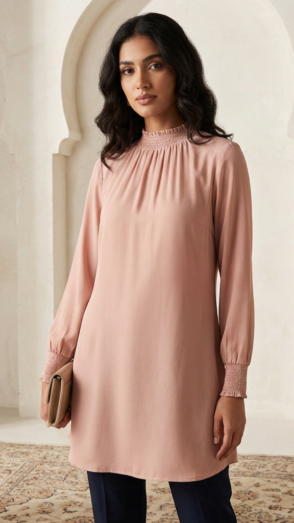 Woman wearing a pink dress in an elegant interior setting
