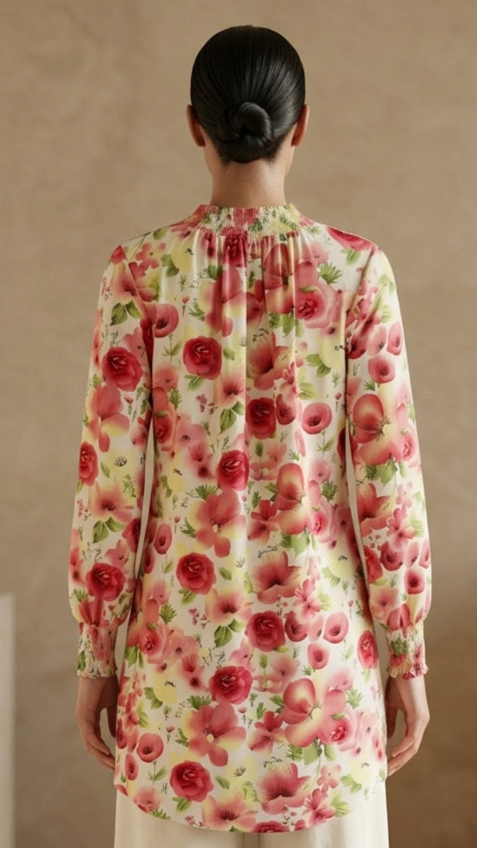 Person wearing a floral long-sleeve top in a minimalistic setting