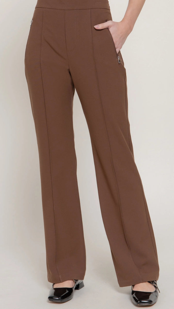 Brown pants worn by a person on a white background