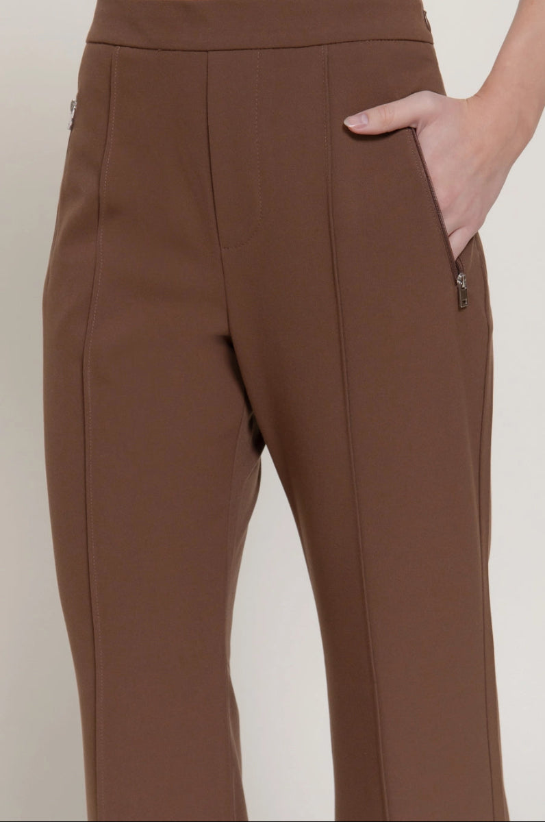 Brown pants worn by a person on a white background