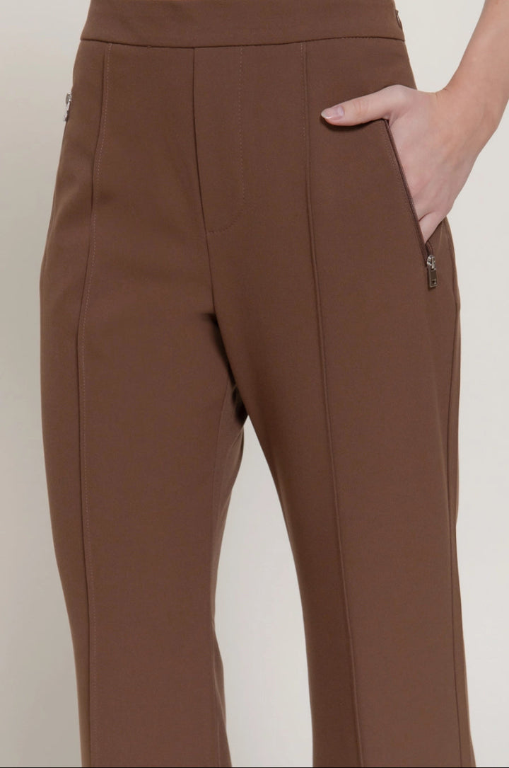 Brown pants worn by a person on a white background