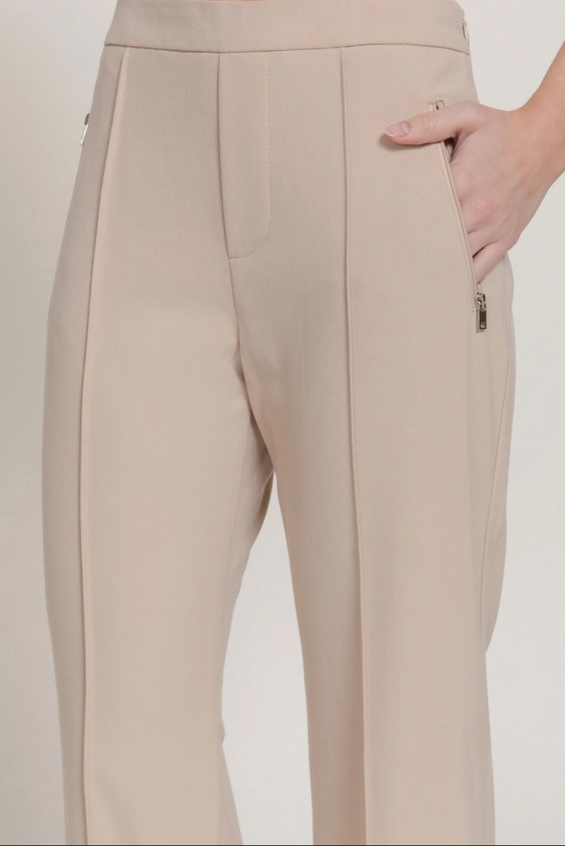 Beige pants worn by a person on a plain background