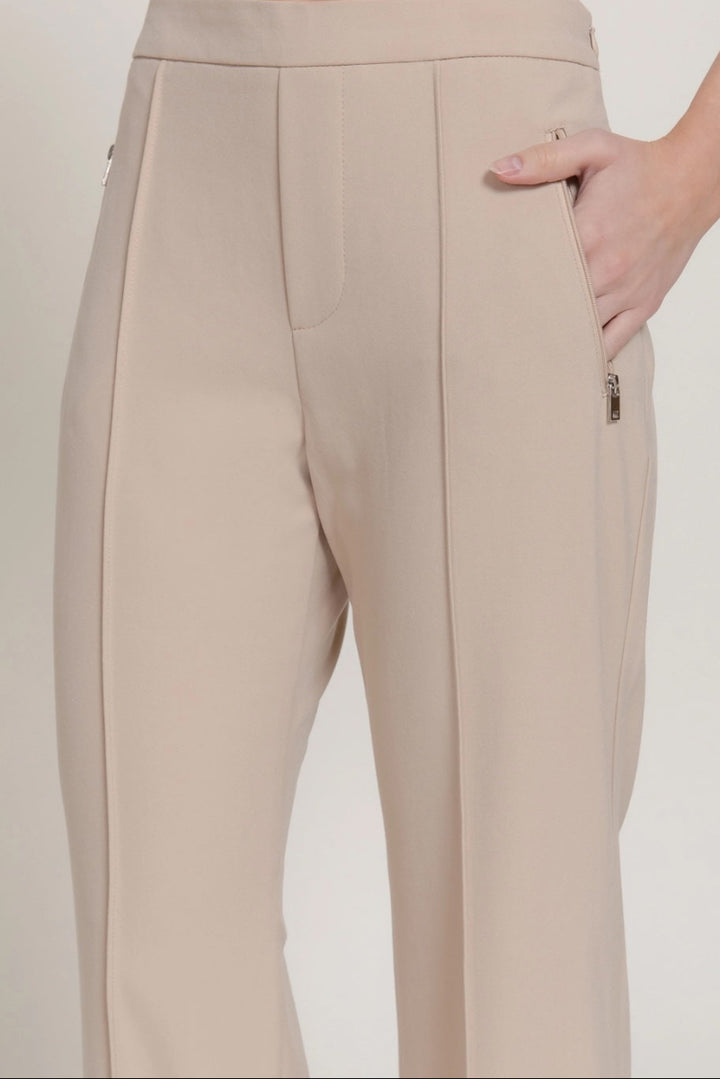 Beige pants worn by a person on a plain background