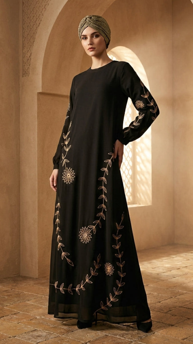 Woman in a black embroidered dress standing in a sunlit archway.