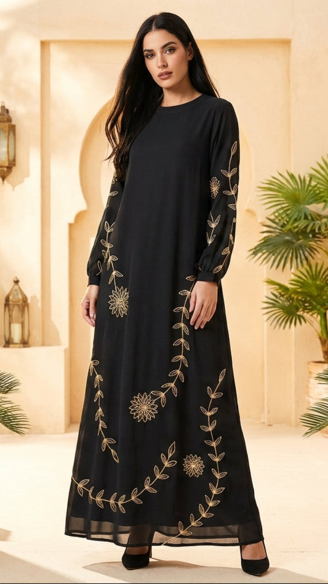 Woman wearing a black dress with gold embroidery in an ornate interior setting.