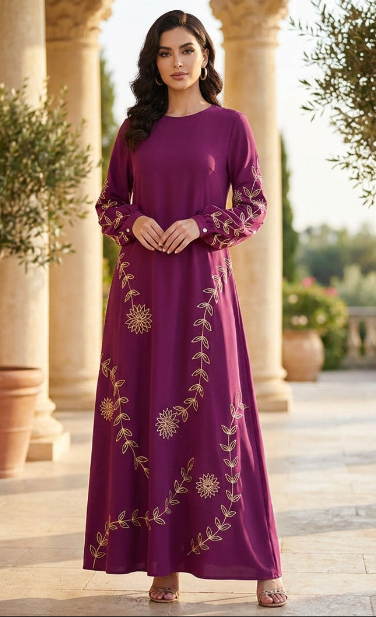 Woman in a purple dress with gold embroidery standing in an outdoor setting with columns and plants.