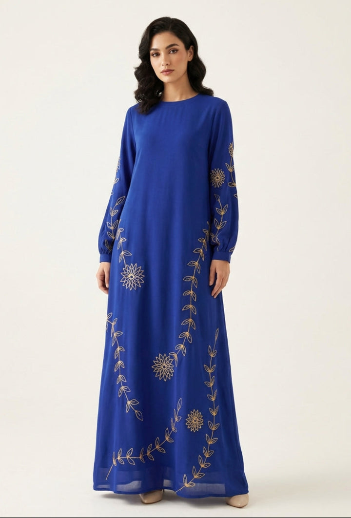 Woman wearing a blue dress with gold embroidery on a white background