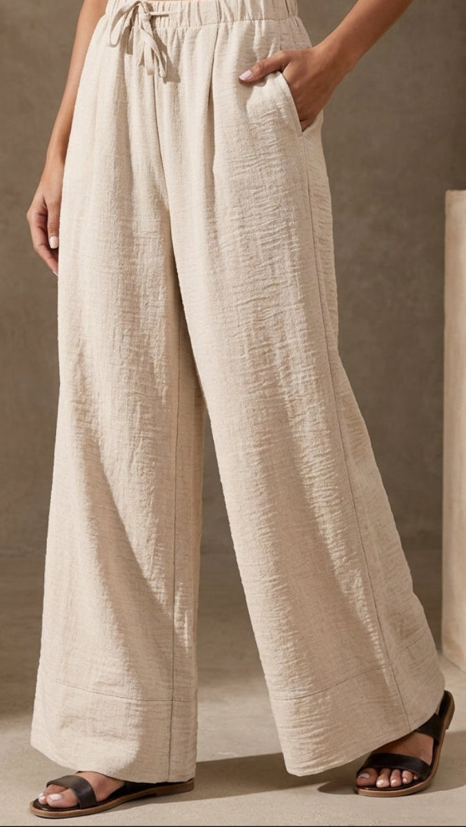 Beige wide-leg pants worn by a person in a neutral setting