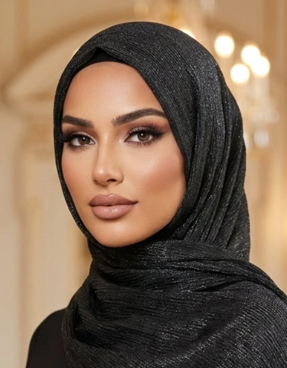 Woman wearing a black hijab with fringe in an elegant interior setting
