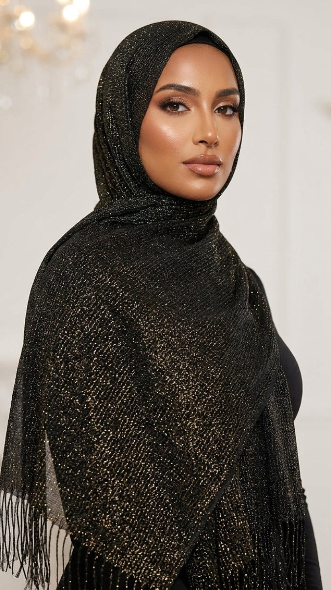 Woman wearing a black shawl with fringe details indoors