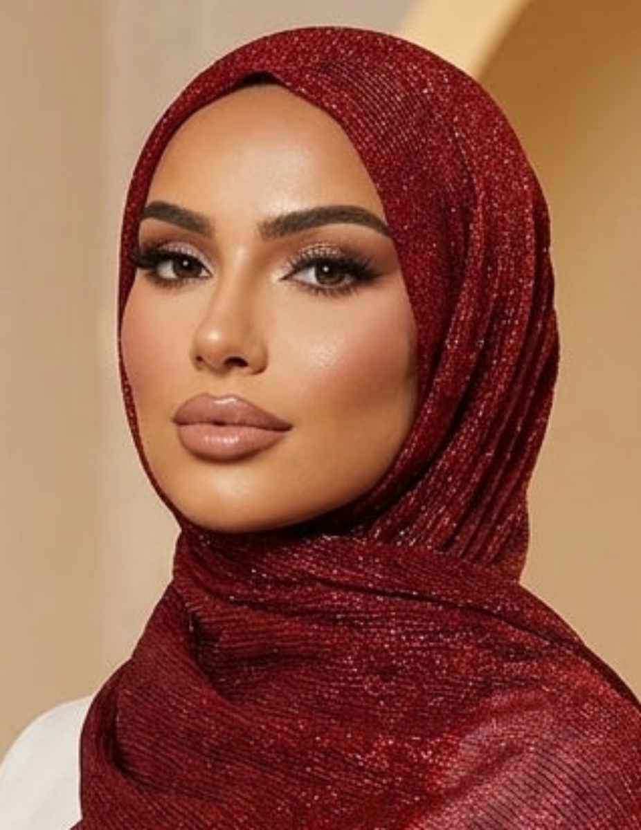 Woman wearing a red hijab with fringe in an ornate interior setting