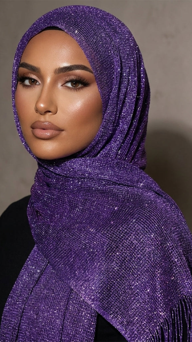 Woman wearing a sparkling purple hijab against a neutral background