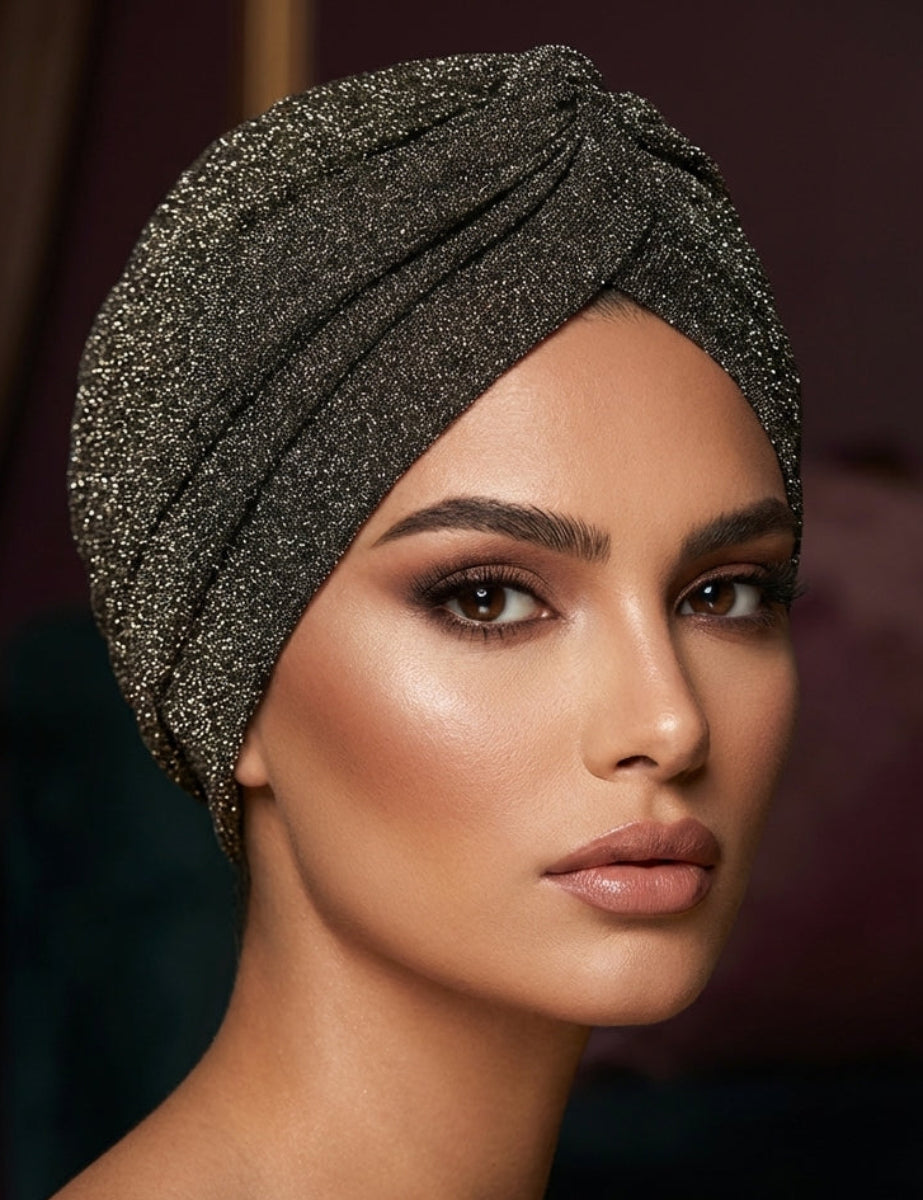 Woman wearing a sparkly black headscarf against a blurred background