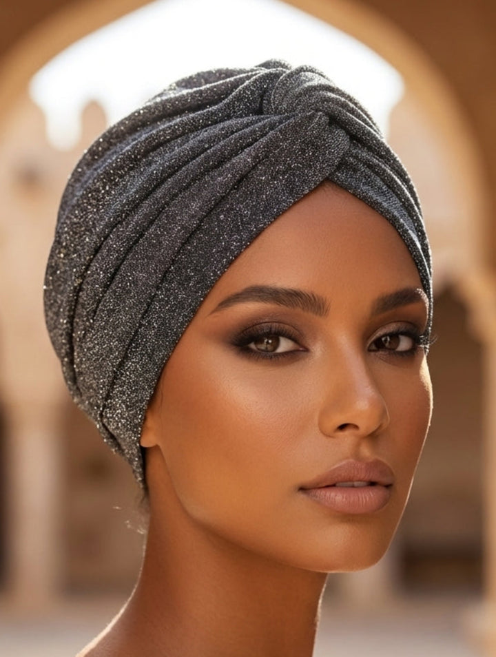 Woman wearing a sparkling headscarf in an arched architectural setting